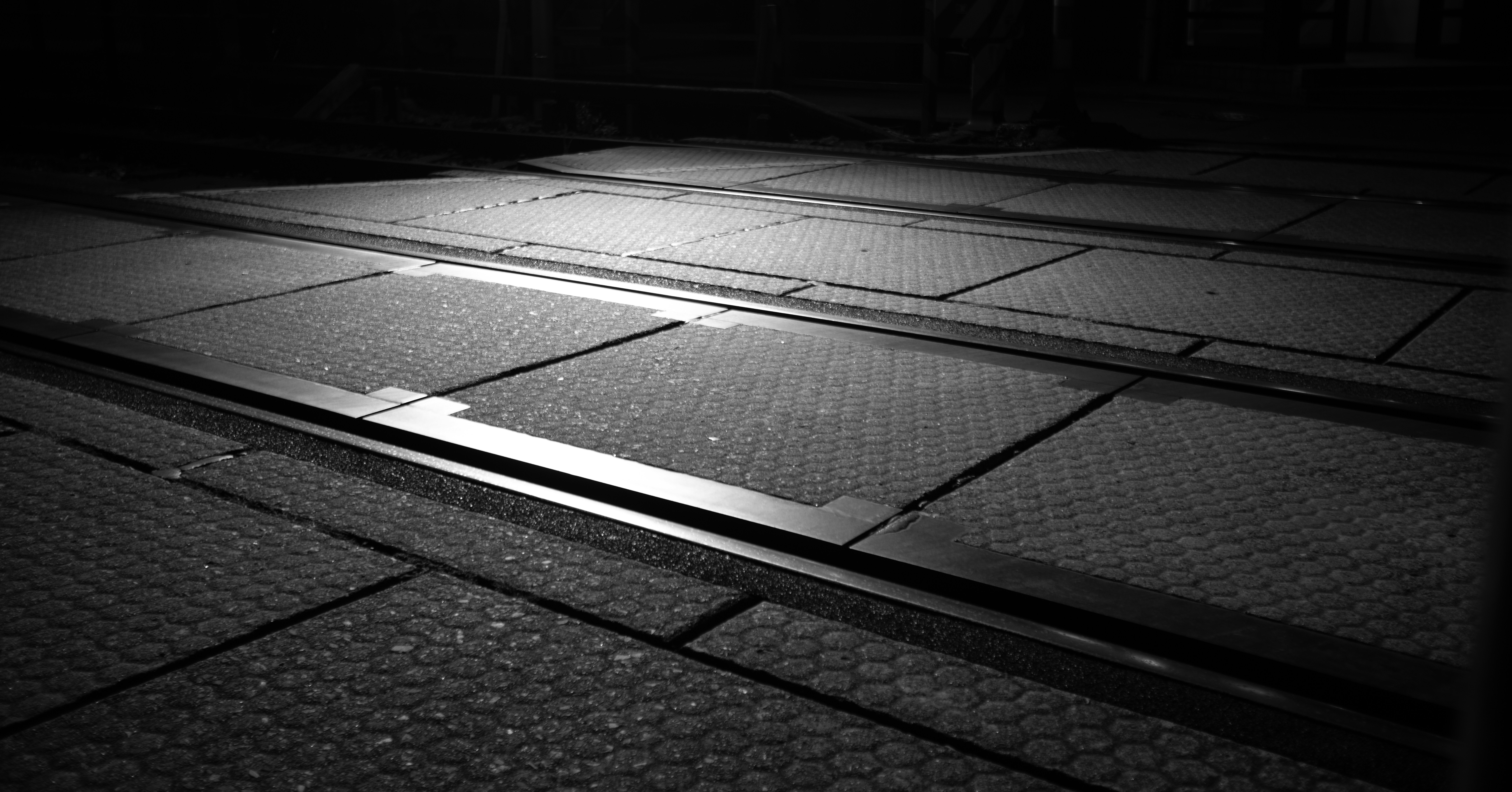 a black and white photo of a train track